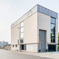 Overall view of the four-story energy plant with vertical facade featuring rough-cut, tongue-and-groove boarding. 