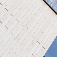 Detailed view of the energy plant’s facade with the different facade treatments compared side by side; pre-greyed, UVood-treated timber