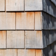The facades comprise traditional shingles applied with a modern vision to create a contemporary construction.