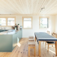 Open and bright dining area and modern kitchen with plenty of wood