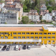 Aerial photograph of the Lattich building with the train station and houses in the background