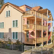 Recycled apartment building with a new external staircase and timber arcades 