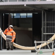 Assembly worker on a mobile phone, coordinating assembly