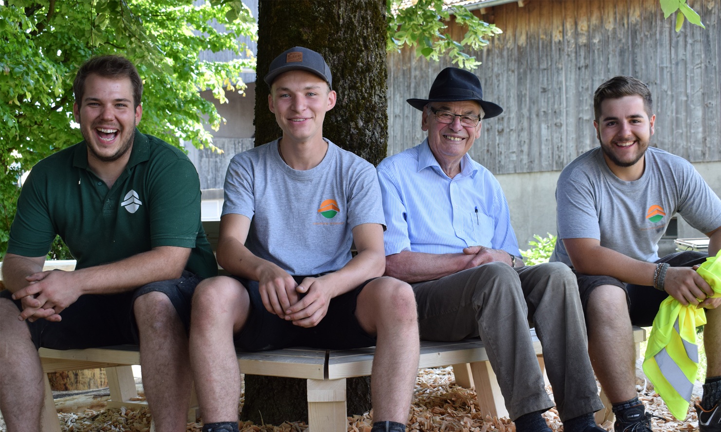 Mr Lehmann senior and apprentices sitting on the finished bench