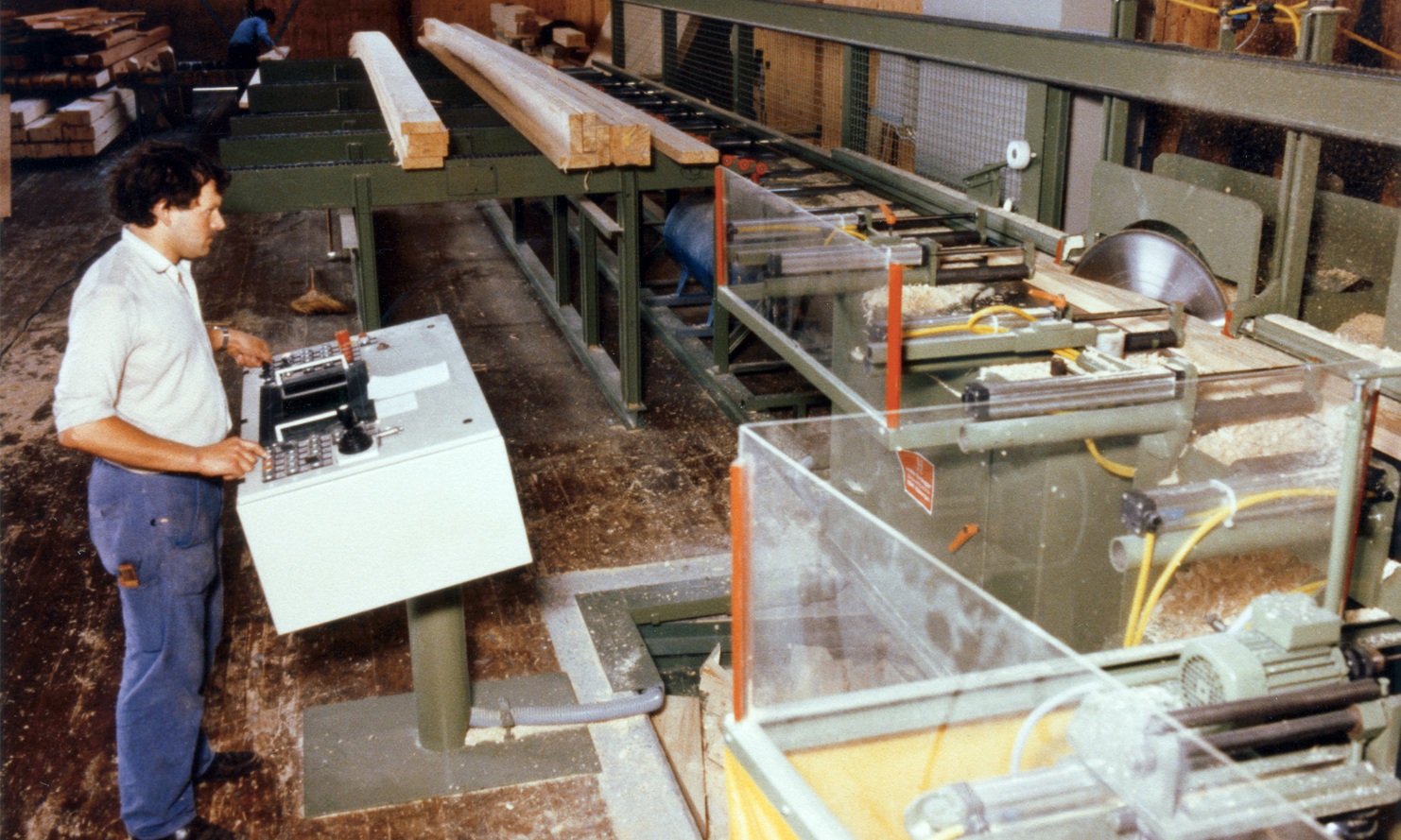 Old photograph of the trimming line, with an employee operating the machinery