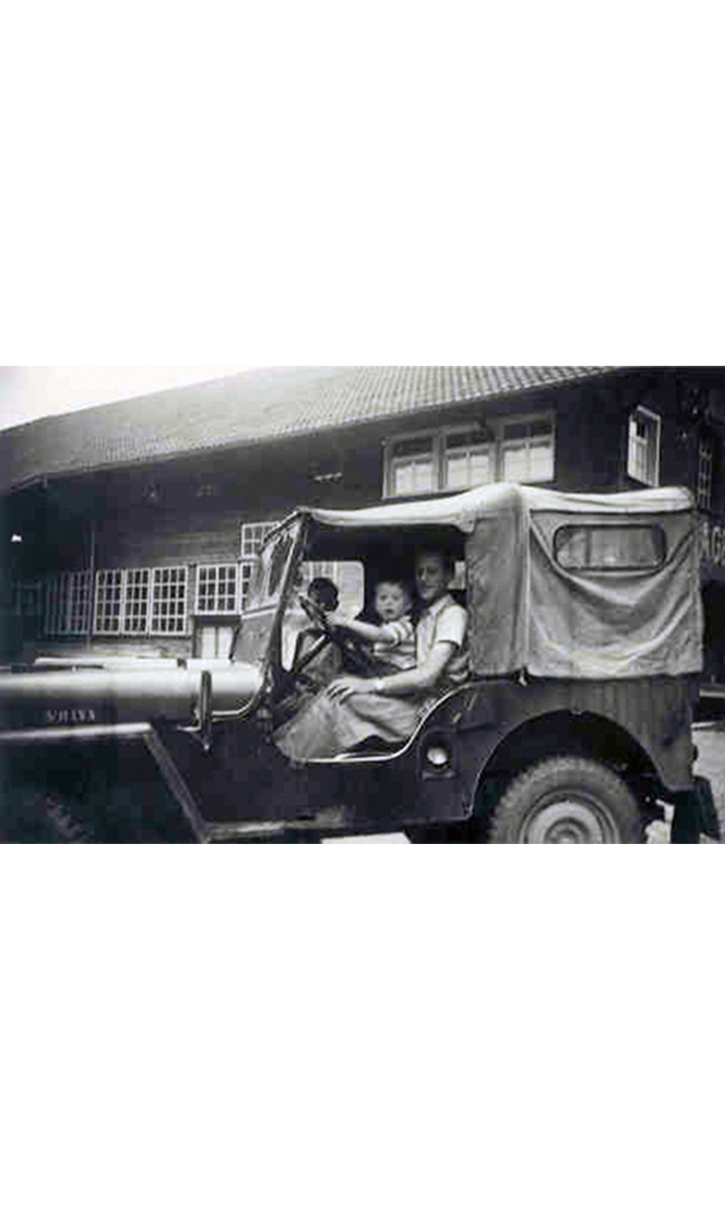 Old photo of a Jeep with Mr Lehmann and his son at the wheel