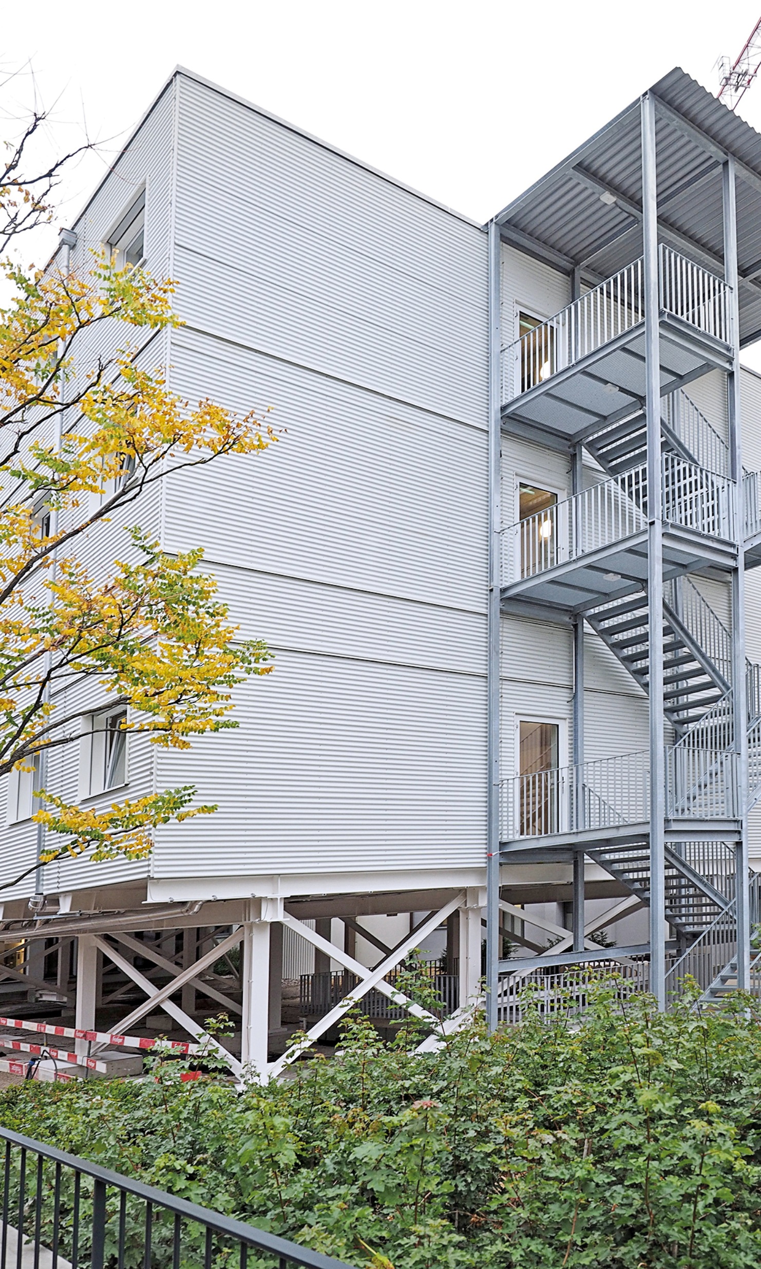 External view of the three-storey temporary hospital building St. Clara from a side perspective with fire escape at the front of the building.