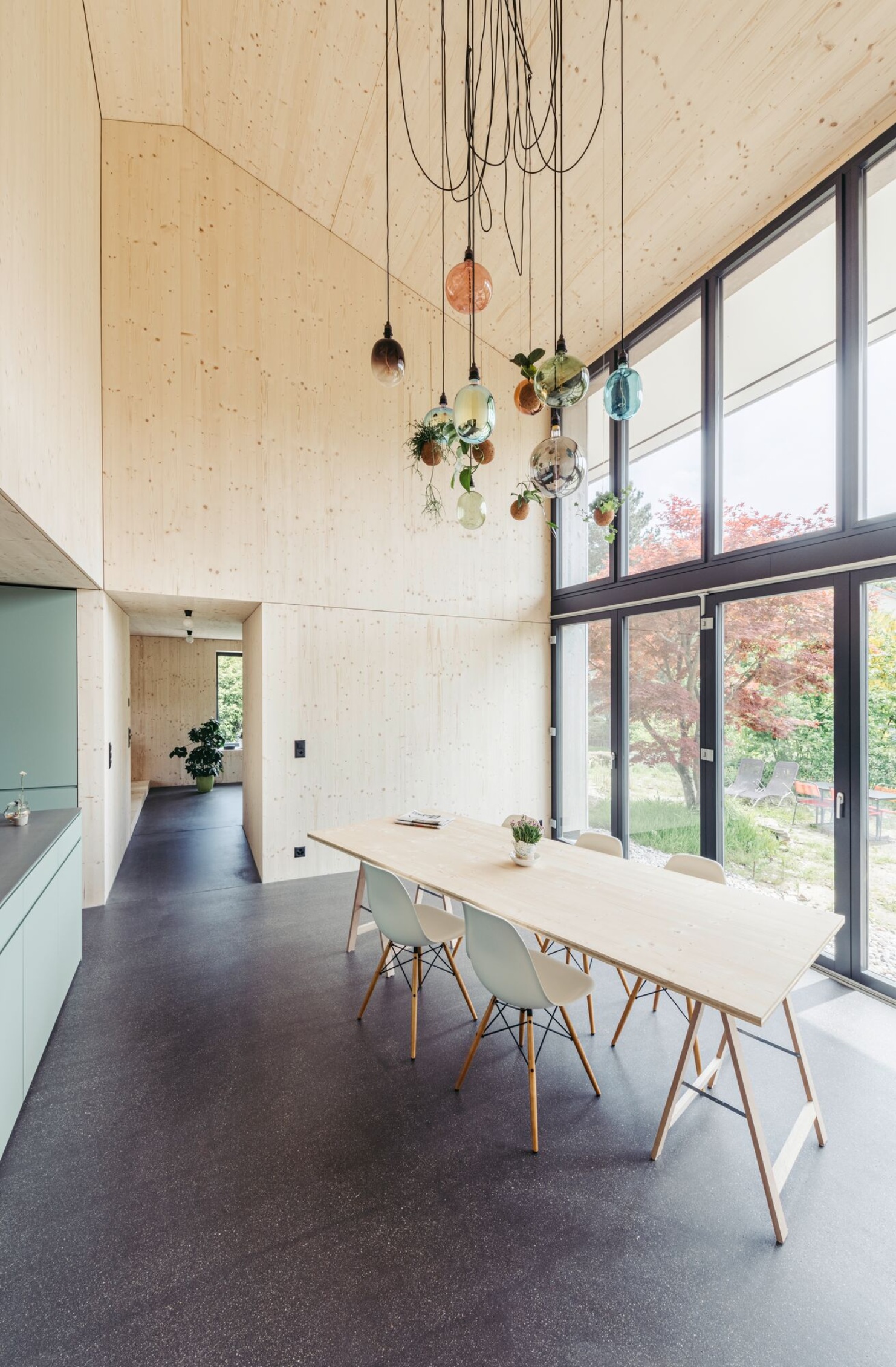 View of the dining room with a long table and chairs in front of the windows