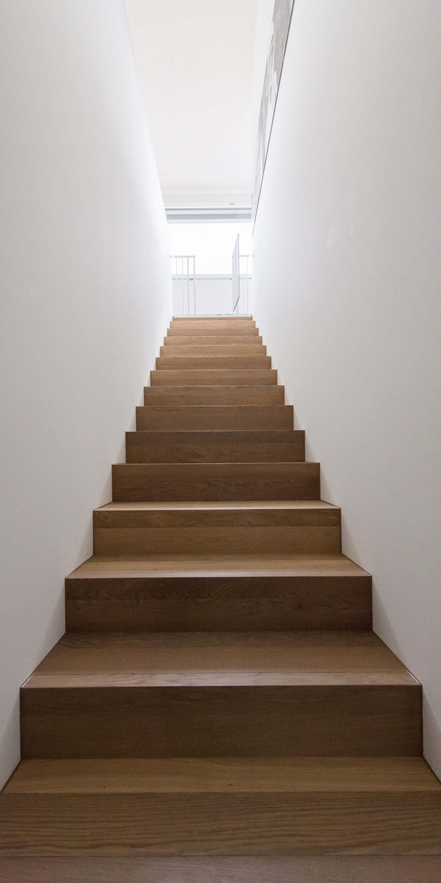 Aufnahme zeigt einen langen Treppenaufgang im Innenbereich des Einfamilienhauses mit Seeblick
