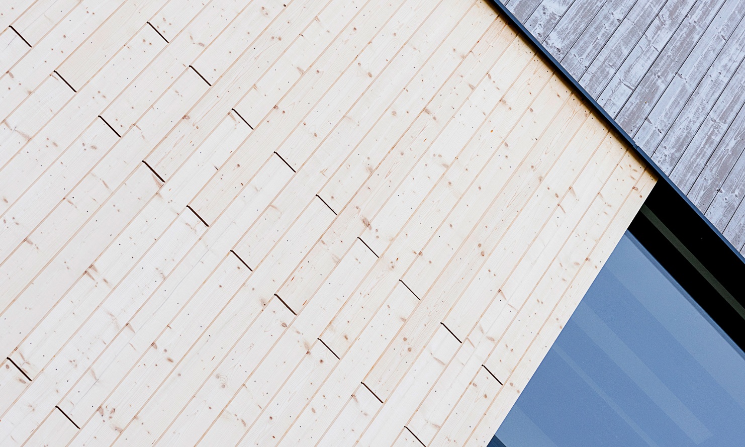 Detailed view of the energy plant’s facade with the different facade treatments compared side by side; pre-greyed, UVood-treated timber