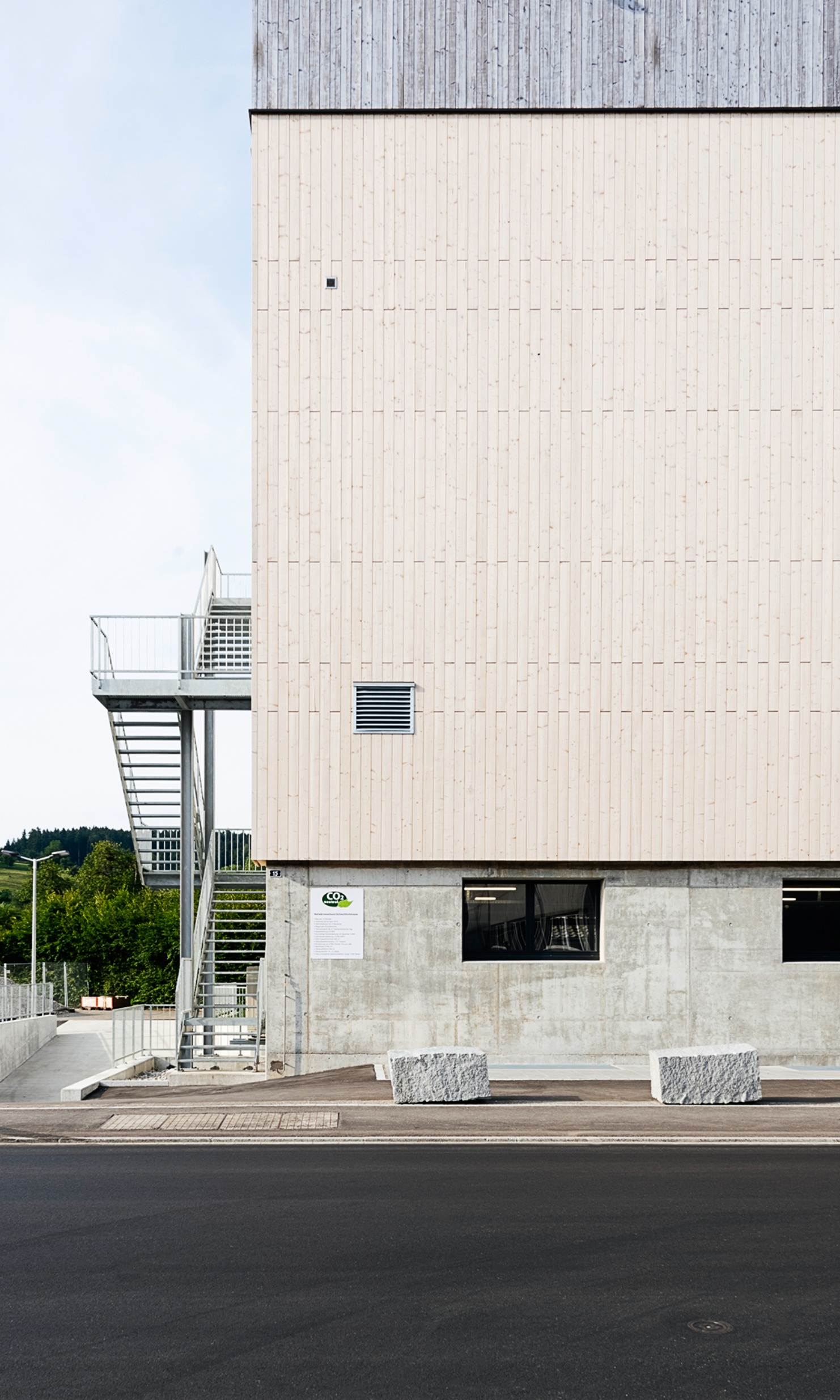 Rear view of the energy plant with staircase access and visibly different timber facades.