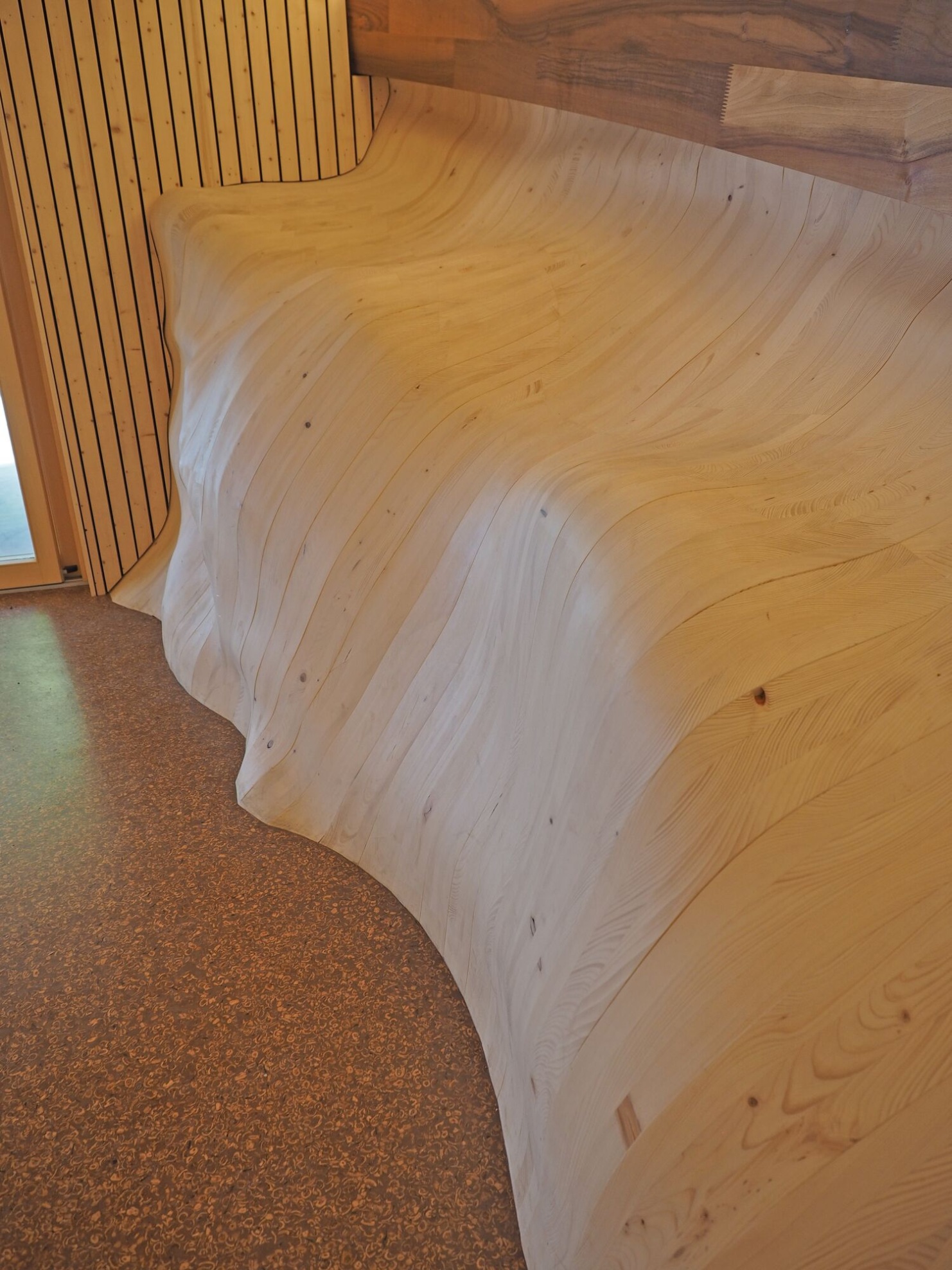 Side walls made of a multitude of uniquely shaped timber components and the floor made of material containing nut shells.