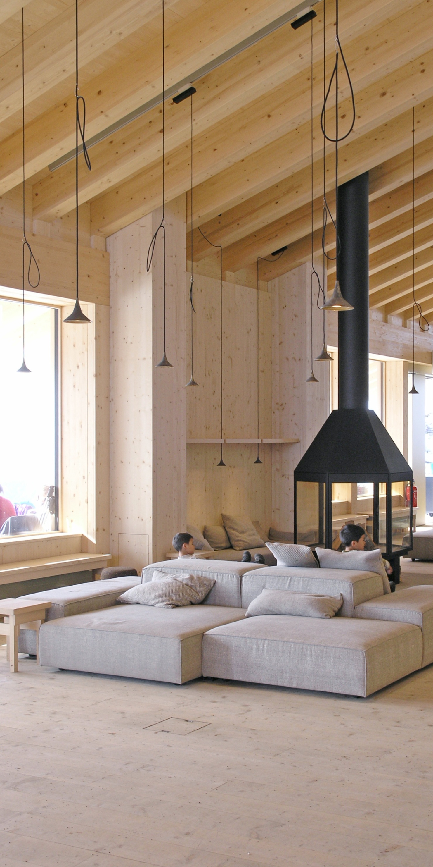 Photograph of a cosy lounge area with fireplace and sofa