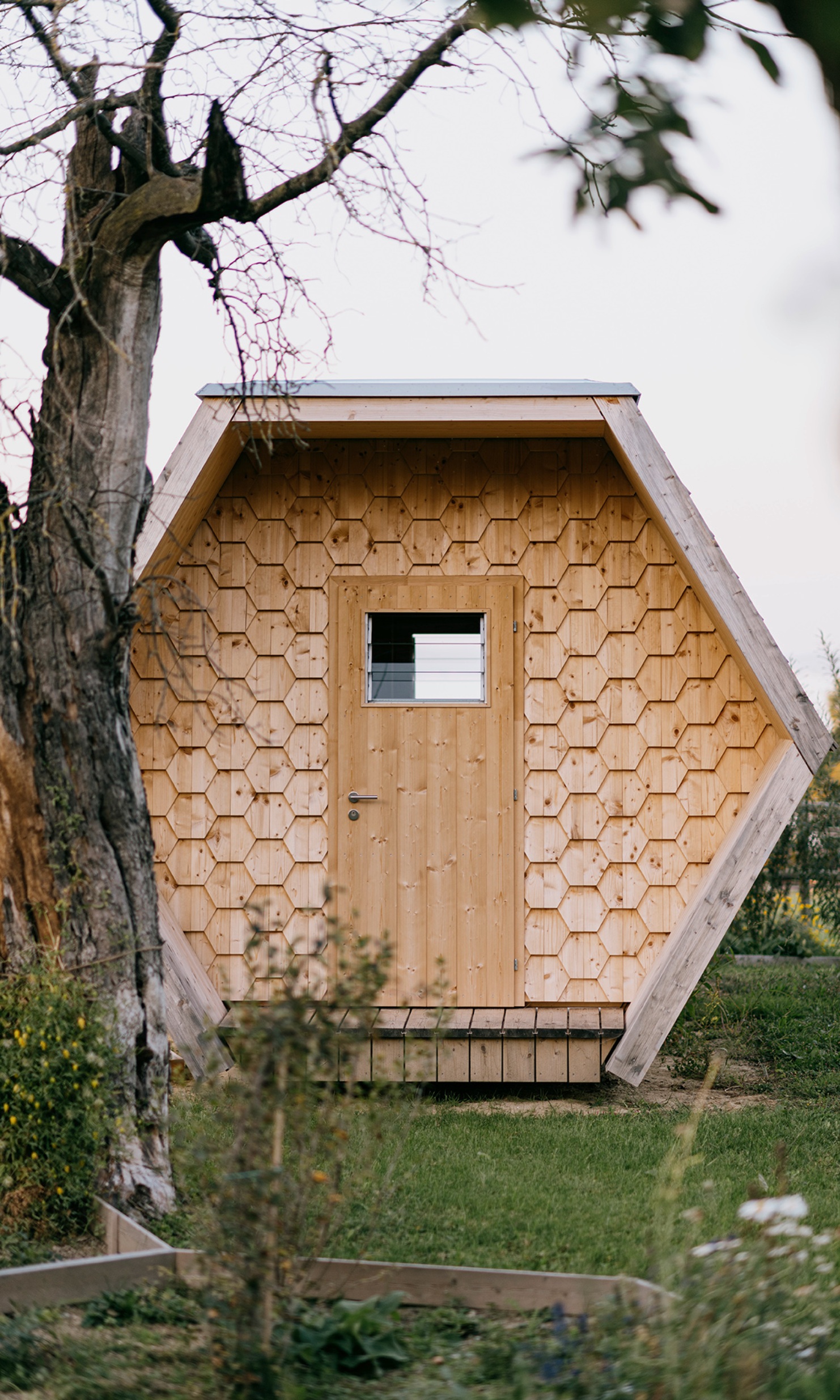 Close-up of the wooden facade and bee entrances of the bee house