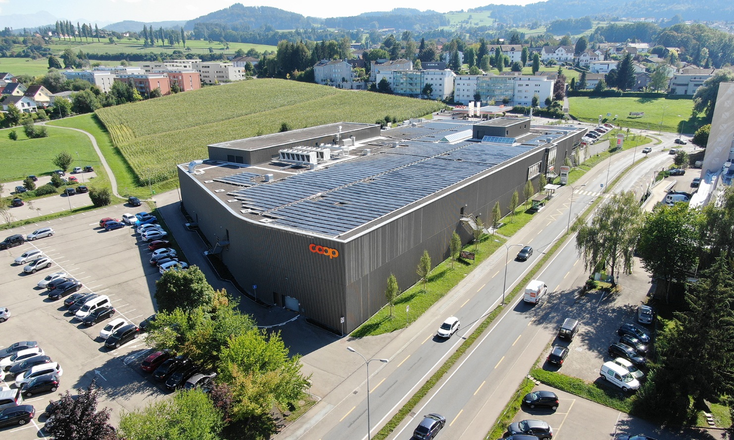 Full bird’s-eye view of the Coop Super Center in Uzwil with pre-greyed timber facade.