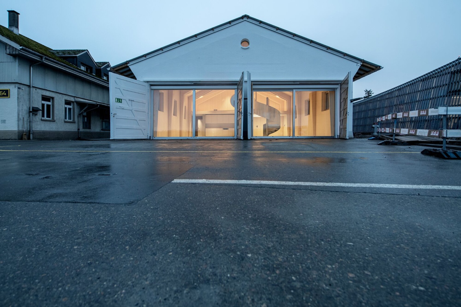 Full view of the former fire station and current coworking space at dusk