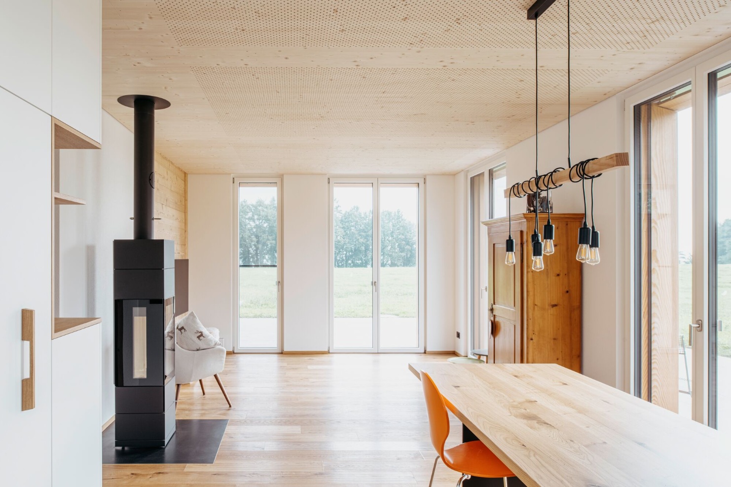 Living room with stove and dining table