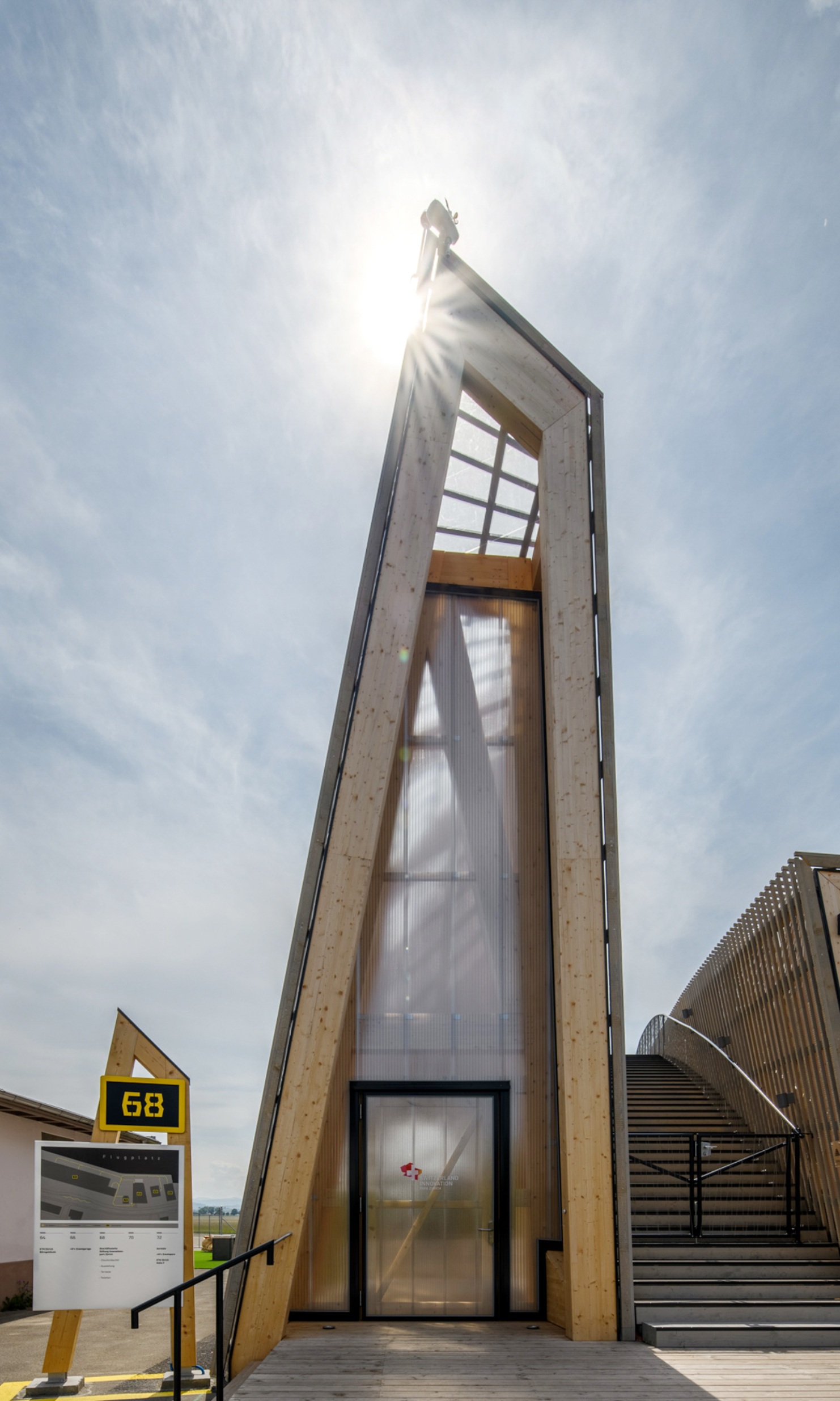 Photograph of the entrance area to Switzerland Innovation Park Zurich in tall, narrow form in fine weather