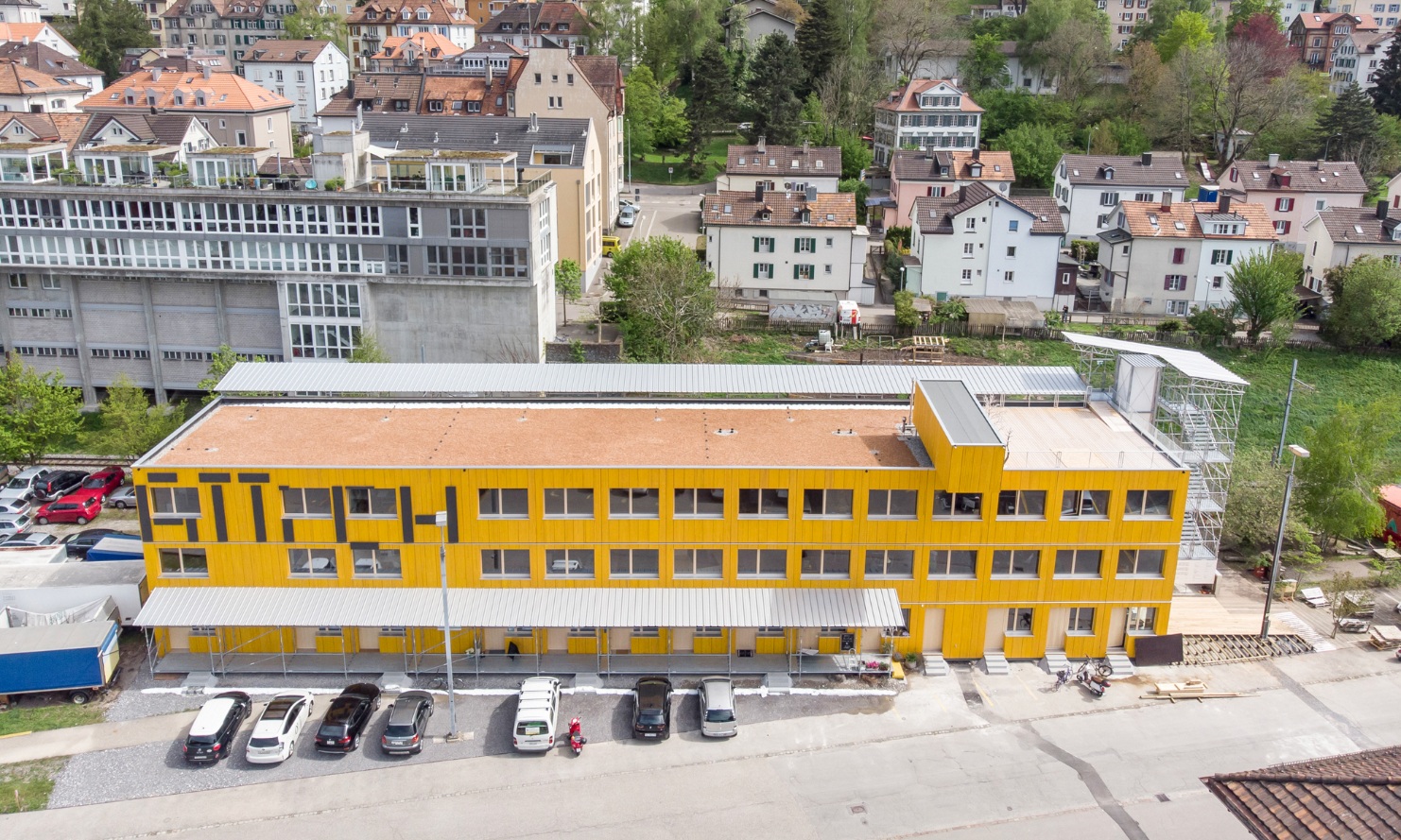 Aerial photograph of the Lattich building with the train station and houses in the background