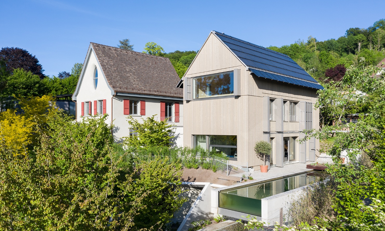 Full view with large garden: 1930s house and new building extension with pool