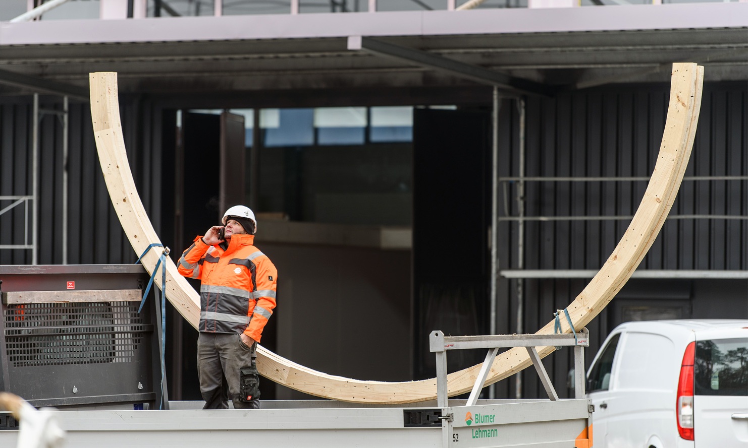 Assembly worker on a mobile phone, coordinating assembly