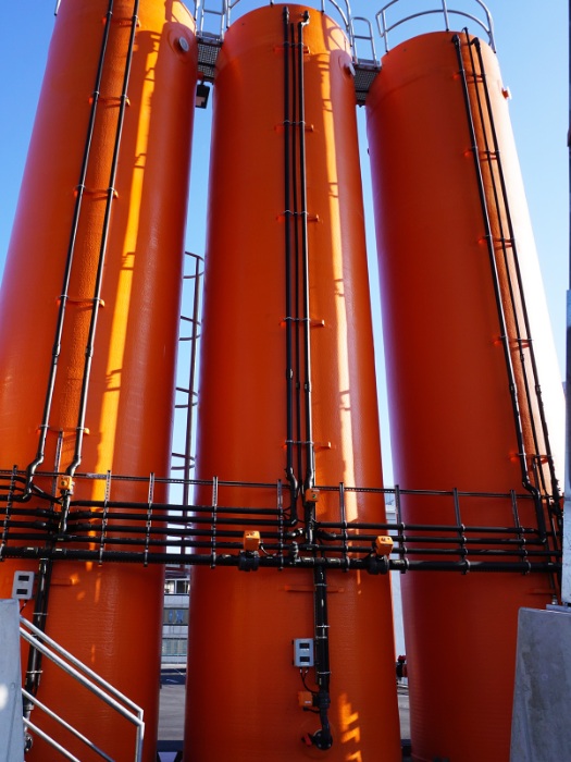 Three orange brine tanks, each with a capacity of 45m3