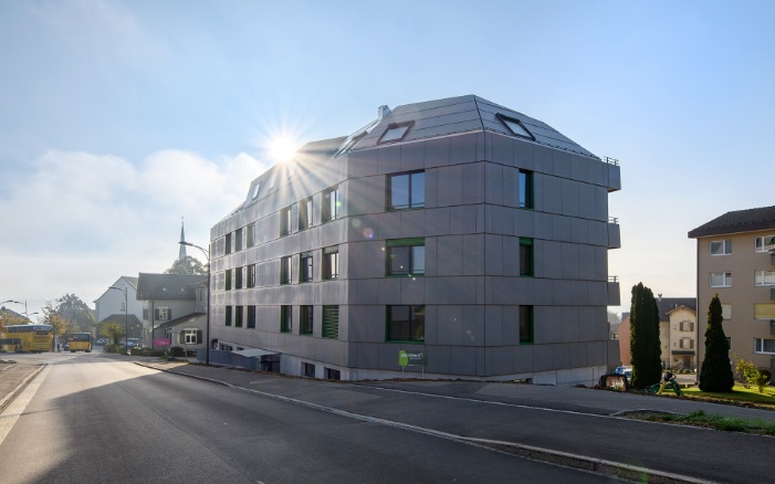 Overall view of the Berg apartment building complex situated directly on the street against a brilliant blue sky