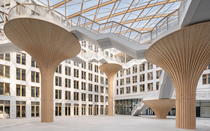 Tree structures of varying heights in the atrium of the EDGE office building in Berlin