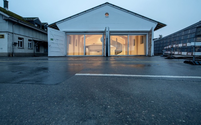 Full view of the former fire station and current coworking space at dusk