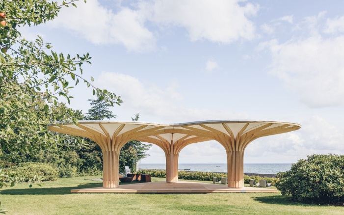 Three timber structures with a membrane covering form the pavilion ‘Into the woods’