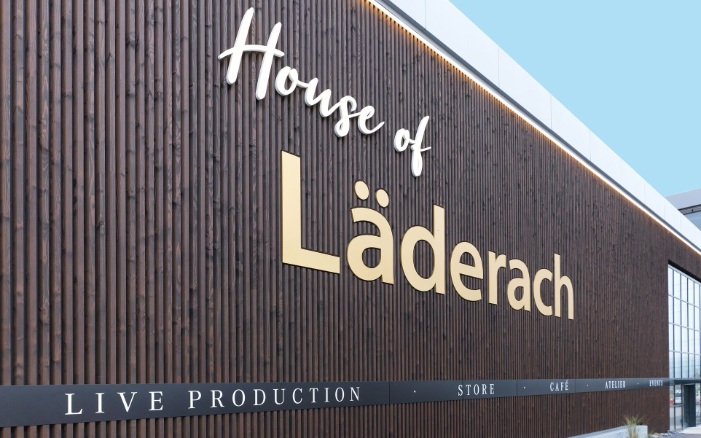 Dark timber facade with milled logo and lettering