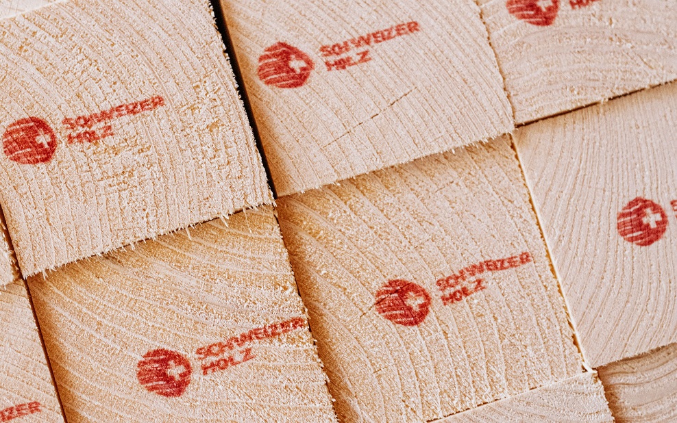 Close-up of square timber, printed with the Swiss timber logo