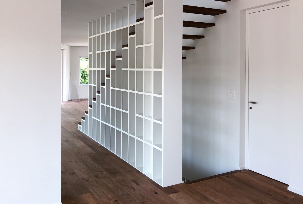 Side view of the staircase in the interior of the single-family house with views of Lake Constance