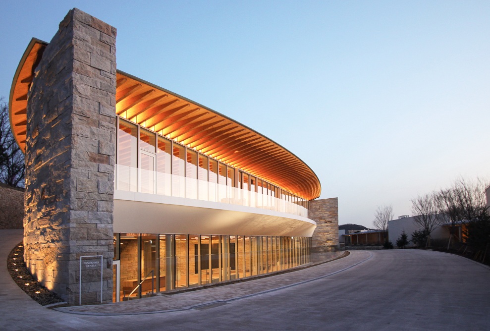 Haesley Nine Bridges Golfklub, Aussenaufnahme Gesamtansicht des Recreation Centre bei Nacht, mit beleuchteten Fenstern und Unterseite des Dachs