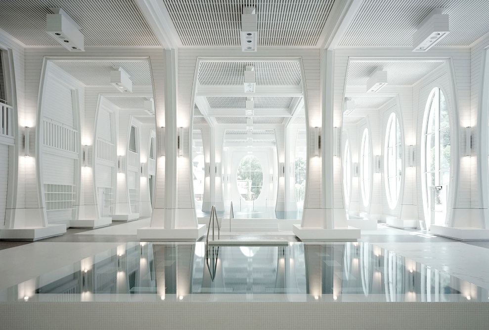 Vue intérieure des Thermes Tamina; salle de bain avec colonnes blanches, éclairée