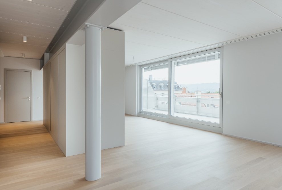 Interior view of the living space with wooden floor in the apartment on the new top floor