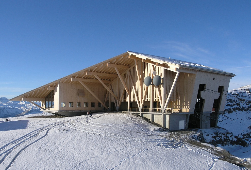 East view of Chäserrugg summit restaurant in Toggenburg in the snow with blue sky