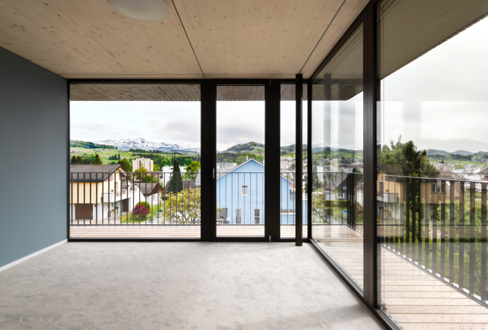 Interior with timber ceiling and floor-to-ceiling glass frontages on two sides