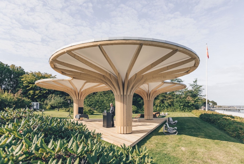 Full view of the timber pavilion with speaker