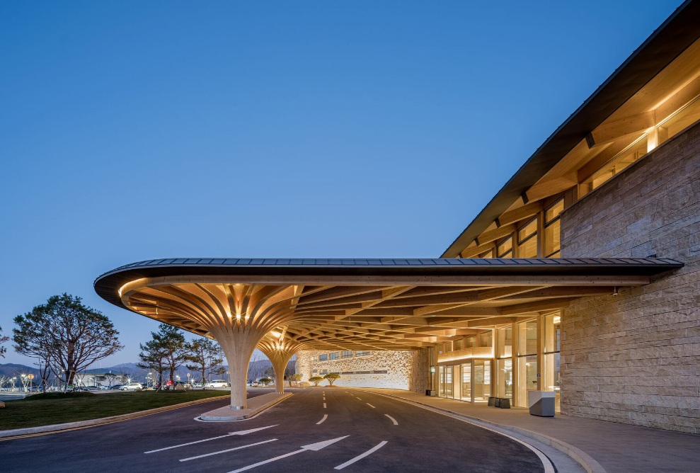 Brightly lit entrance to Hillmaru Country Club at dusk