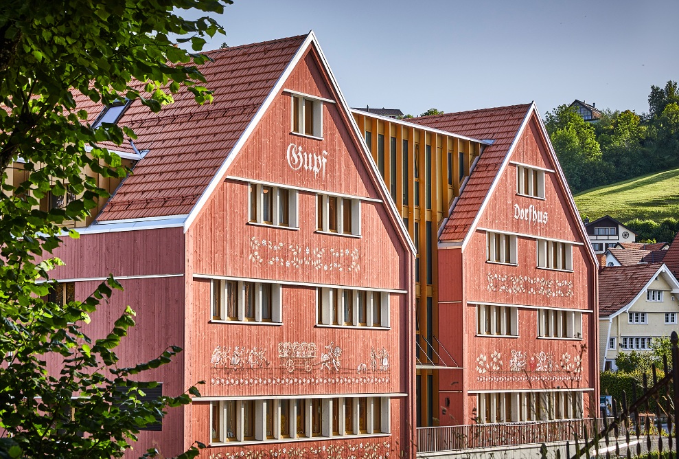 Red-brown façade of the Dorfhus Gupf in the village of Rehetobel