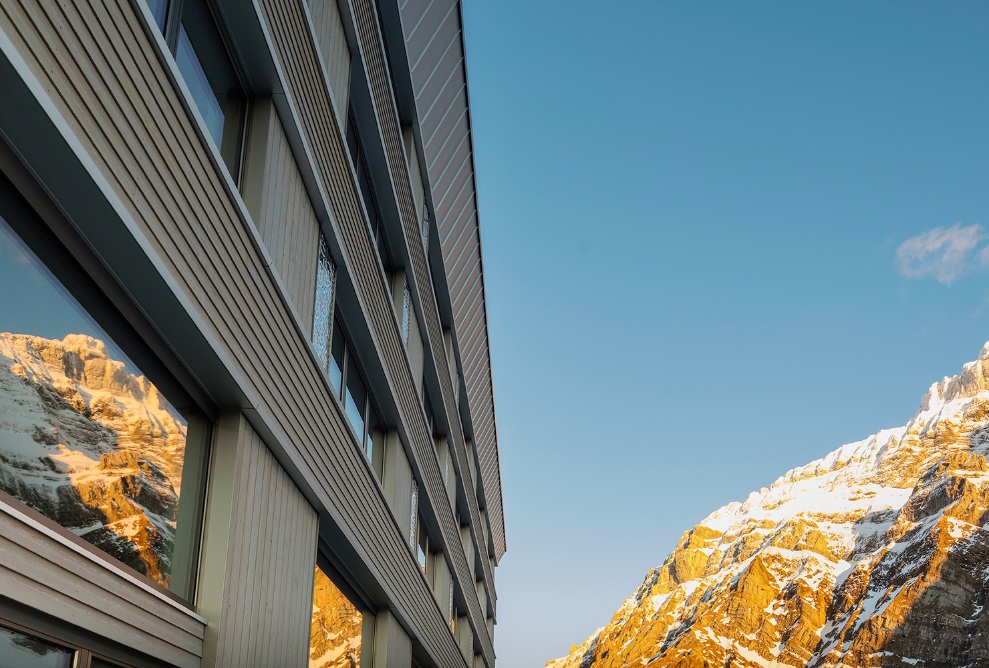 Fassadenansicht des Hotels Säntis und Blick auf den Säntis bei Morgendämmerung