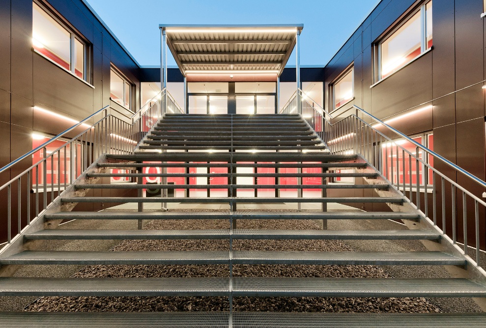 The photograph shows the wide steps to the Baden cantonal school