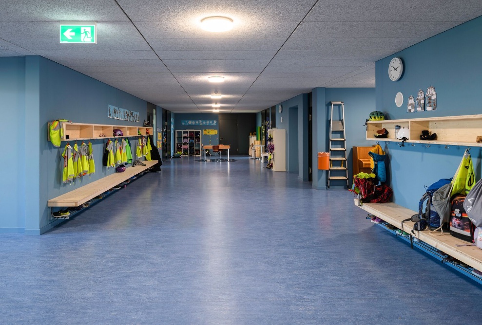 Modern cloakroom with colorful jackets and school bags in the Herti school facility