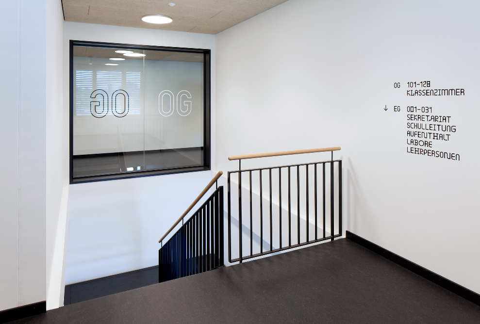 Stairwell with black flooring and information marked on the walls