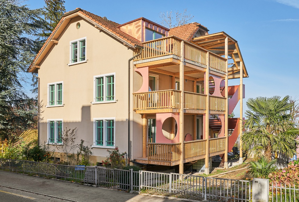 Recycled apartment building with a new external staircase and timber arcades 