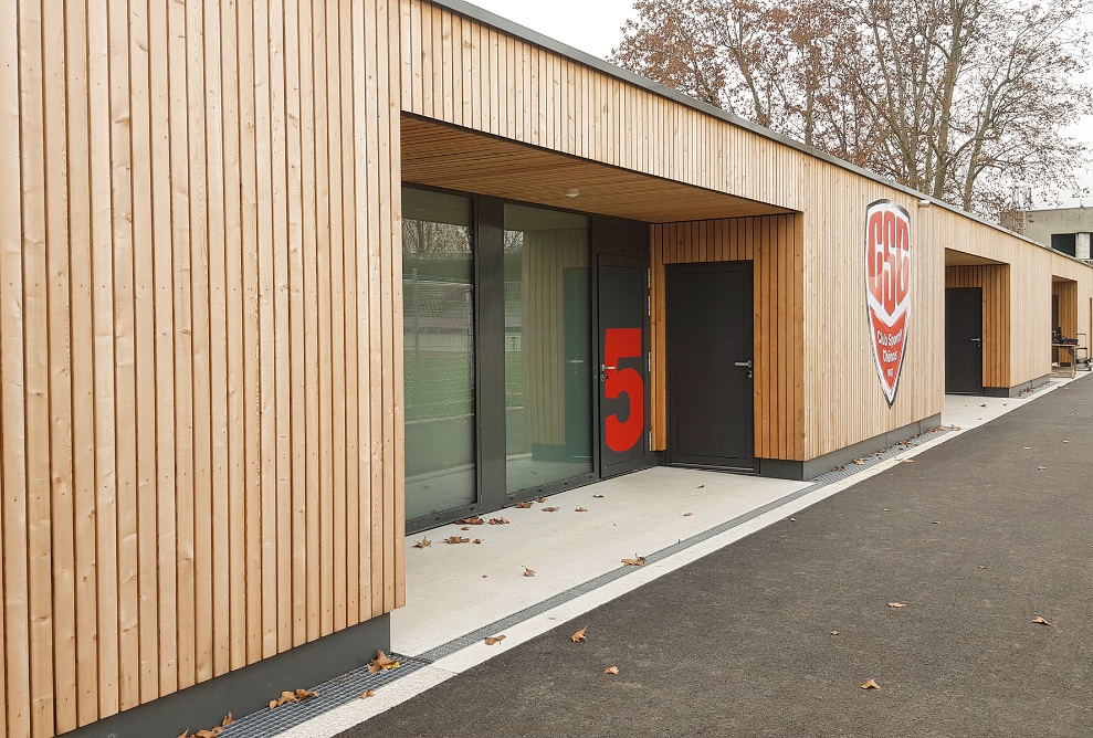 Holzfassade mit Eingang der Stadionerweiterung des Stade des trois Chênes 