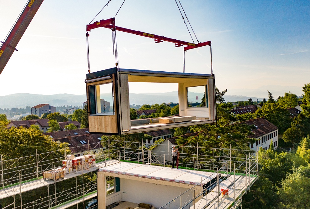 A ZM10 timber module is lifted onto the roof of Friesenberg primary school by crane and put into place.